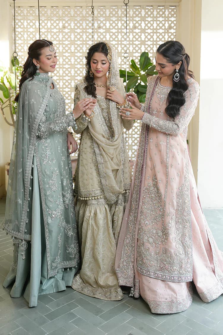 Three models in embroidered couture
