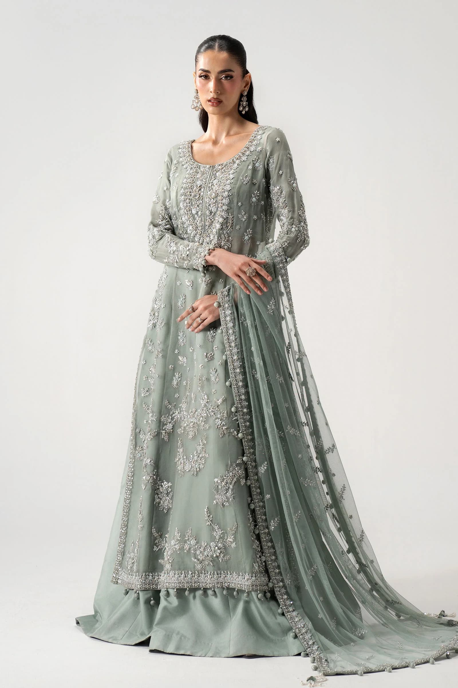 Model in a seafoam hand-embroidered couture gown
