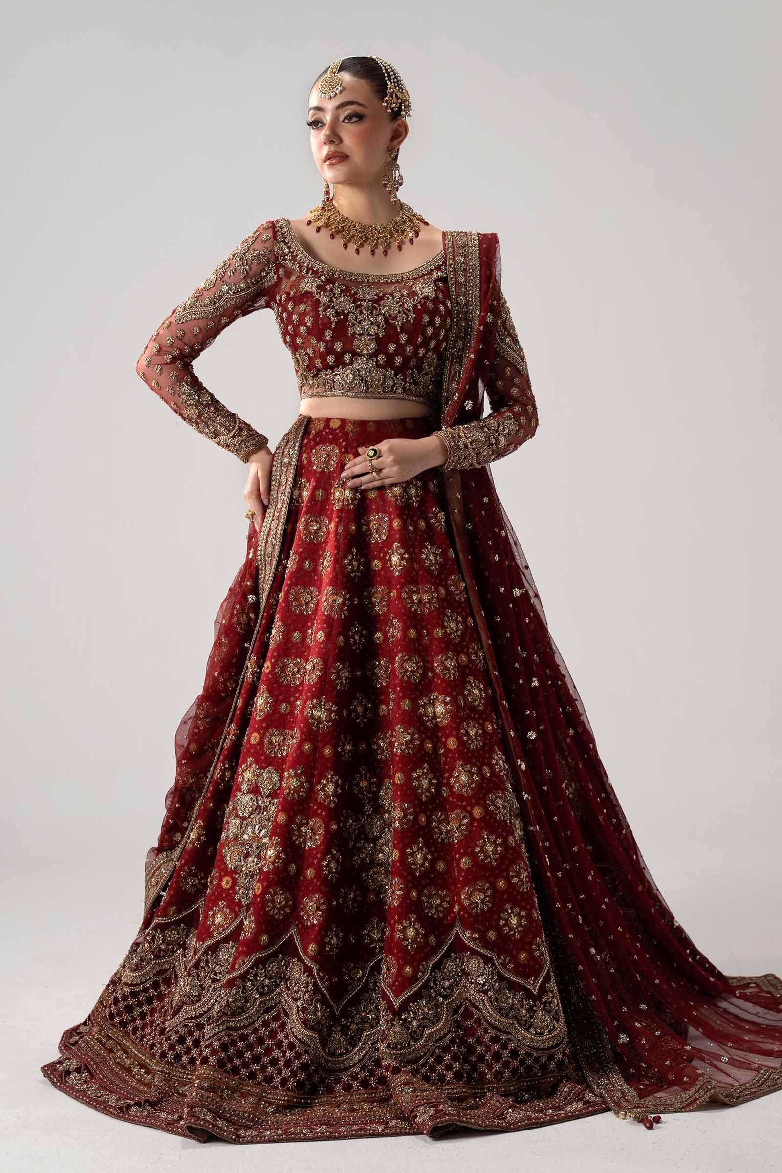 Model in a crimson bridal couture lehenga