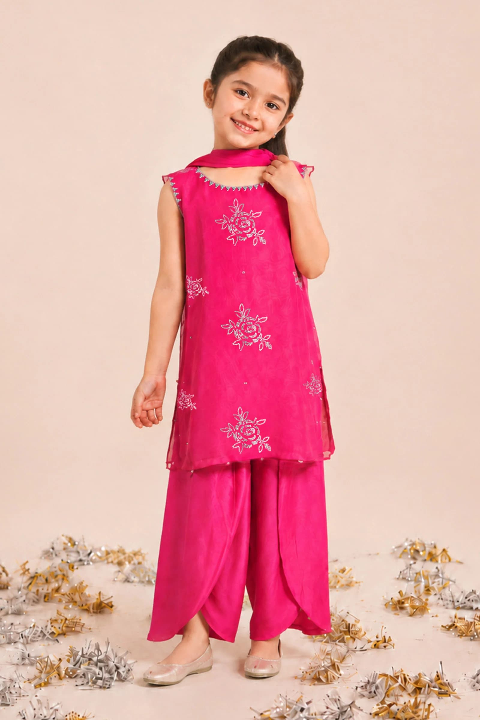 Girl in a fuchsia embroidered kurta and shalwar set