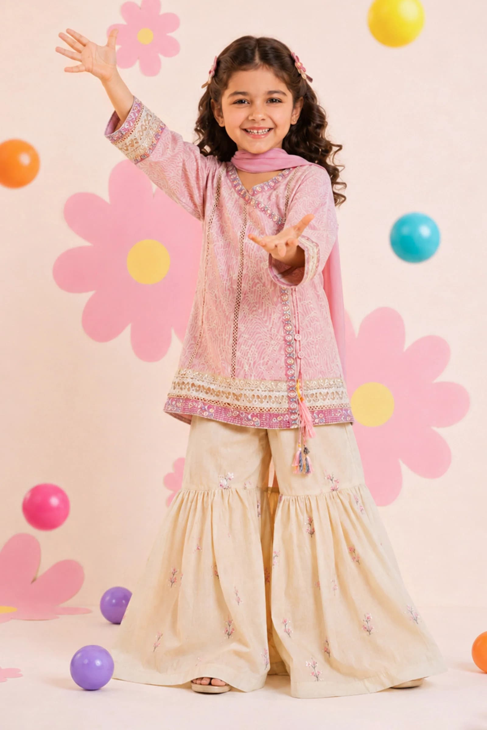 Girl in a pink embroidered top with a cream sharara