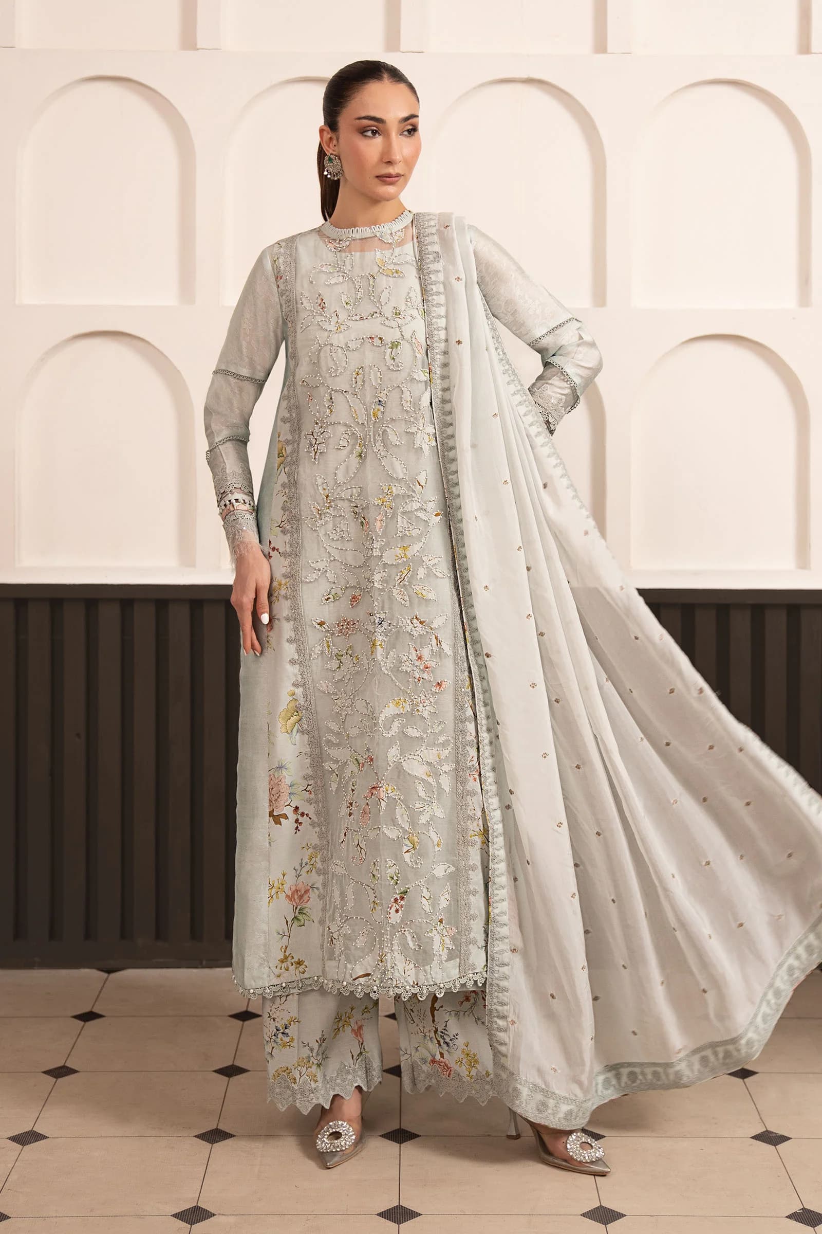 Model in an ivory embroidered three-piece with dupatta