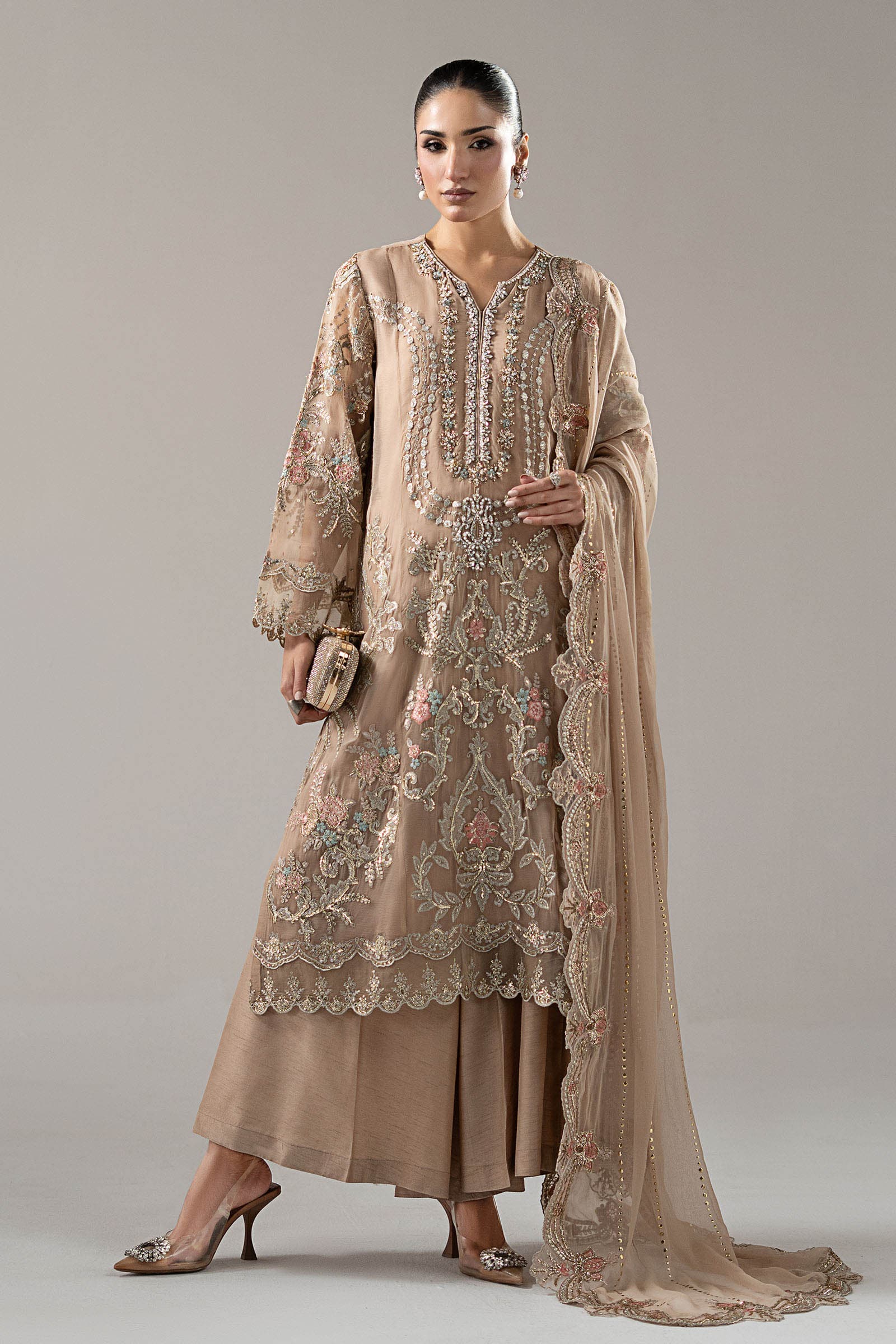 Model in a champagne embroidered open gown