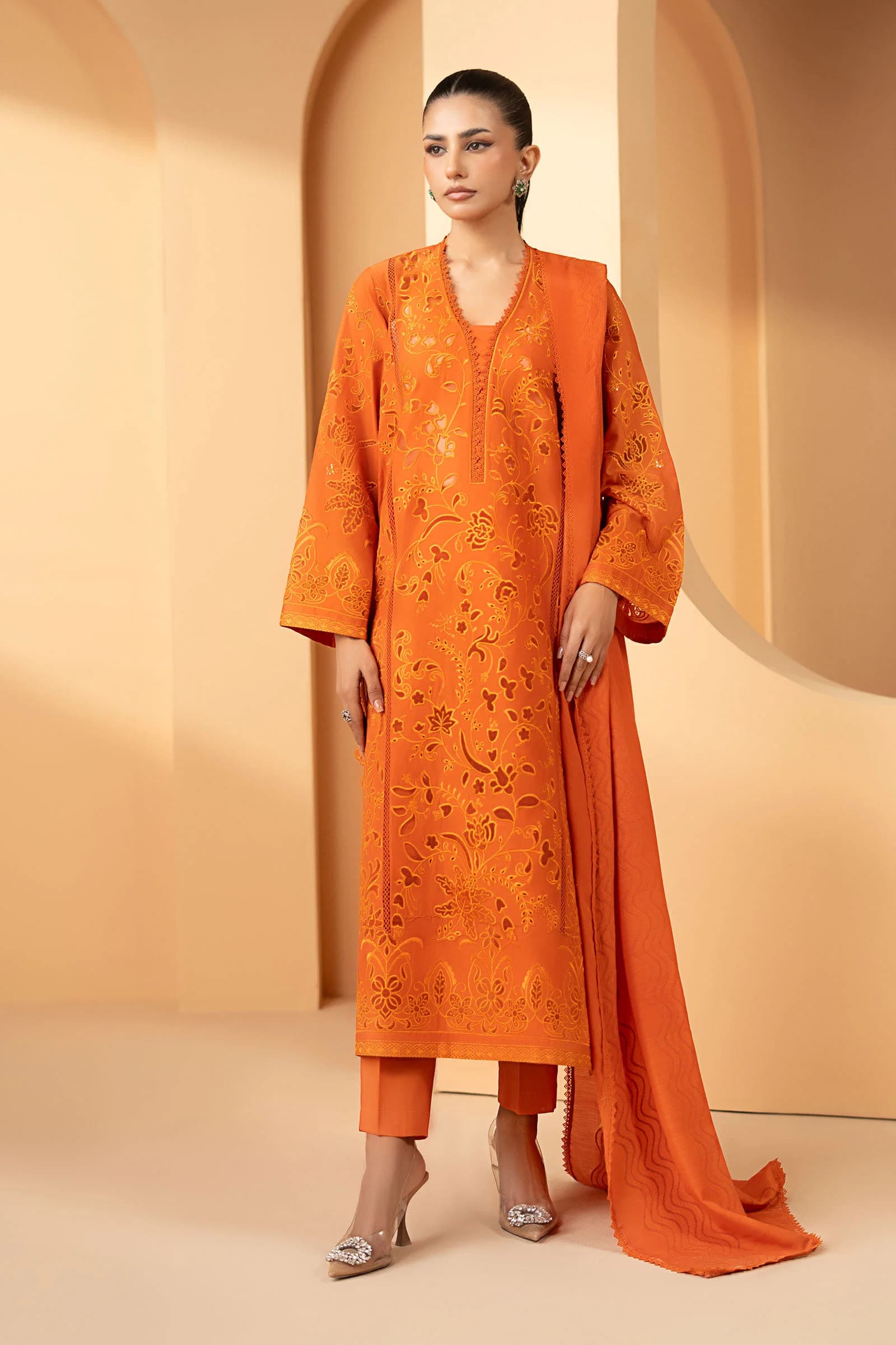 Model in a rust embroidered suit with dupatta
